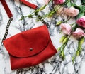 Red leather bag and flowers Royalty Free Stock Photo