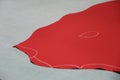 Red leather with chalk lines on grey surface
