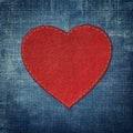 Red leather heart on fabric in grunge style Royalty Free Stock Photo
