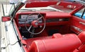 Red leather interior with steering wheel and dash of Licoln Continental convertible from Sixties Royalty Free Stock Photo