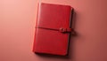 Red leather notebook with strap closure. Smooth textured cover. Ideal for journaling, diary writing, or personal notes. Elegant Royalty Free Stock Photo