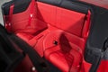 Red leather passenger seats in convertible sports car Royalty Free Stock Photo