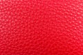 Red leather pebble texture background close up