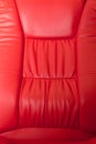 Red leather recliner, closeup detail, skin texture