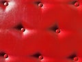 Red leather upholstery. Furniture upholstery with red buttons