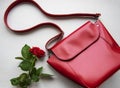 Red leather women bag and rose Royalty Free Stock Photo