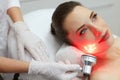 Red Led Light Treatment. Woman Doing Facial Skin Therapy Royalty Free Stock Photo