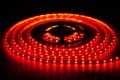 Red LED strip on reel with black background Royalty Free Stock Photo