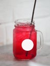 Red lemon soda water flavoured drink, Cool Drinks Beverages with ice in clear glass on white table Royalty Free Stock Photo