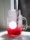 Red lemon soda water flavoured drink, Cool Drinks Beverages with ice in clear glass on white table Royalty Free Stock Photo