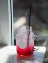 Red lemon soda water flavoured drink, Cool Drinks Beverages with ice in clear glass on white table Royalty Free Stock Photo