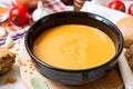 Red lentil cream soup in dark ceramic bowl Royalty Free Stock Photo