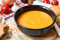 Red lentil cream soup in dark ceramic bowl Royalty Free Stock Photo