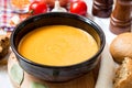 Red lentil cream soup in dark ceramic bowl Royalty Free Stock Photo