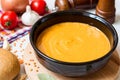 Red lentil cream soup in dark ceramic bowl Royalty Free Stock Photo