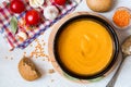 Red lentil cream soup in dark ceramic bowl Royalty Free Stock Photo