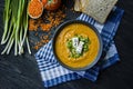 Red lentil cream soup decorated with fresh vegetables and greens. Veggie concept. Proper nutrition. View from above Royalty Free Stock Photo