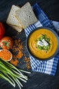 Red lentil cream soup decorated with fresh vegetables and greens. Veggie concept. Proper nutrition. View from above Royalty Free Stock Photo