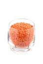 Red lentils in glass, white background