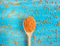 Red Lentils or Masoor Dal in wooden spoon on light blue background. Top view. Flat lay. Colorful and stylish composition. Royalty Free Stock Photo