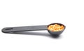 Red lentils on measuring spoon and white background Royalty Free Stock Photo