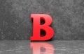 Red letter B on concrete wall an floor background Royalty Free Stock Photo
