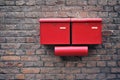 Red letter boxes on old brick wall Horizontal image. Royalty Free Stock Photo