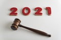 Red lettering 2021 and judges gavel or hammer for auction on white background