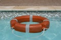 Red life buoy floating in swimming pool