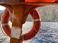 Red Life buoy in front of the blue sea and the white ship Royalty Free Stock Photo