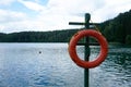 Red life buoy on the shore of the lake, Green Lakes, Vilnius Royalty Free Stock Photo