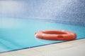 Red life buoy in swimming pool.. Help and support concept. Royalty Free Stock Photo