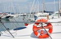 Red life buoy tangled on sailing boat detail Royalty Free Stock Photo