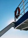A Red Life Preserver on a Ferry Against a Blue Sky Royalty Free Stock Photo