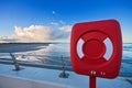 Red life ring by a beach at sunset Royalty Free Stock Photo