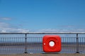 Red life saver on railings st the seaside