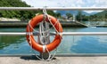 Red lifebelt, safety rope, pier near lake