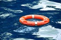 Red lifebuoy in blue water. Royalty Free Stock Photo