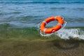 Red lifebuoy flying in the sea wave Royalty Free Stock Photo