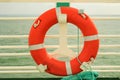 Red Lifebuoy in front of the blue sea and the white ship Royalty Free Stock Photo