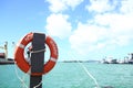 Red lifebuoy hanging on the pole Royalty Free Stock Photo