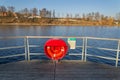 Red lifebuoy hanging on wooden pier, Jordan pond, Tabor, oldest dam in the Czech Republic, sunny autumn day, life insurance Royalty Free Stock Photo