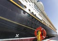 Red lifebuoy and side of a cruise ship