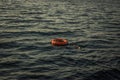 Red lifebuoy thrown overboard in the black sea
