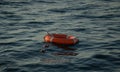 Red lifebuoy thrown overboard in the black sea