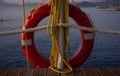 A red lifebuoy and yellow ropes are hanging on the pier Royalty Free Stock Photo