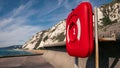 Red lifeguard sign near the Samphire Hoe seafront, England, on a sunny day