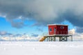 Red lifeguard tower on the coast covered with snow Royalty Free Stock Photo