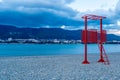 the red lifeguard tower on the pebble beach of the resort town is out of season. No people, empty beach. Winter, clouds Royalty Free Stock Photo