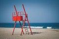 Red lifeguard watchtower on empty beach Royalty Free Stock Photo